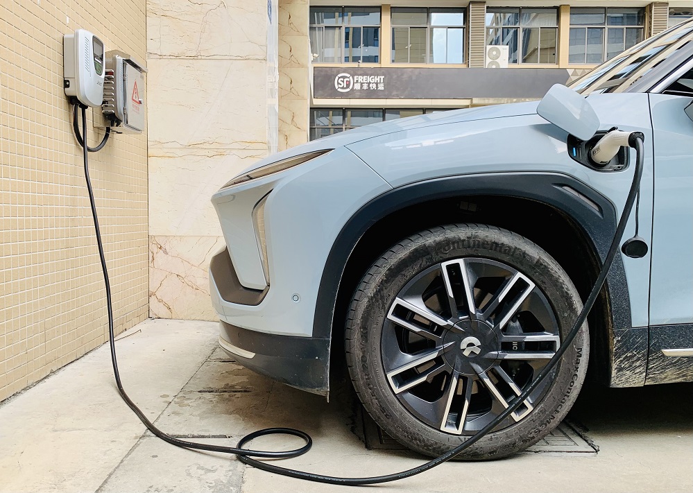 The Joint EVC10 is a commercial EV charger that is charging an electric vehicle